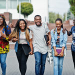 Home group of five african college students spending time together on